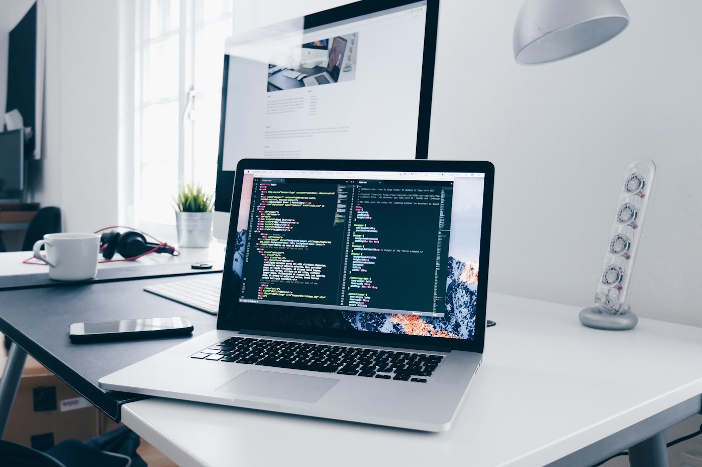 A bright workspace with website development open on a laptop